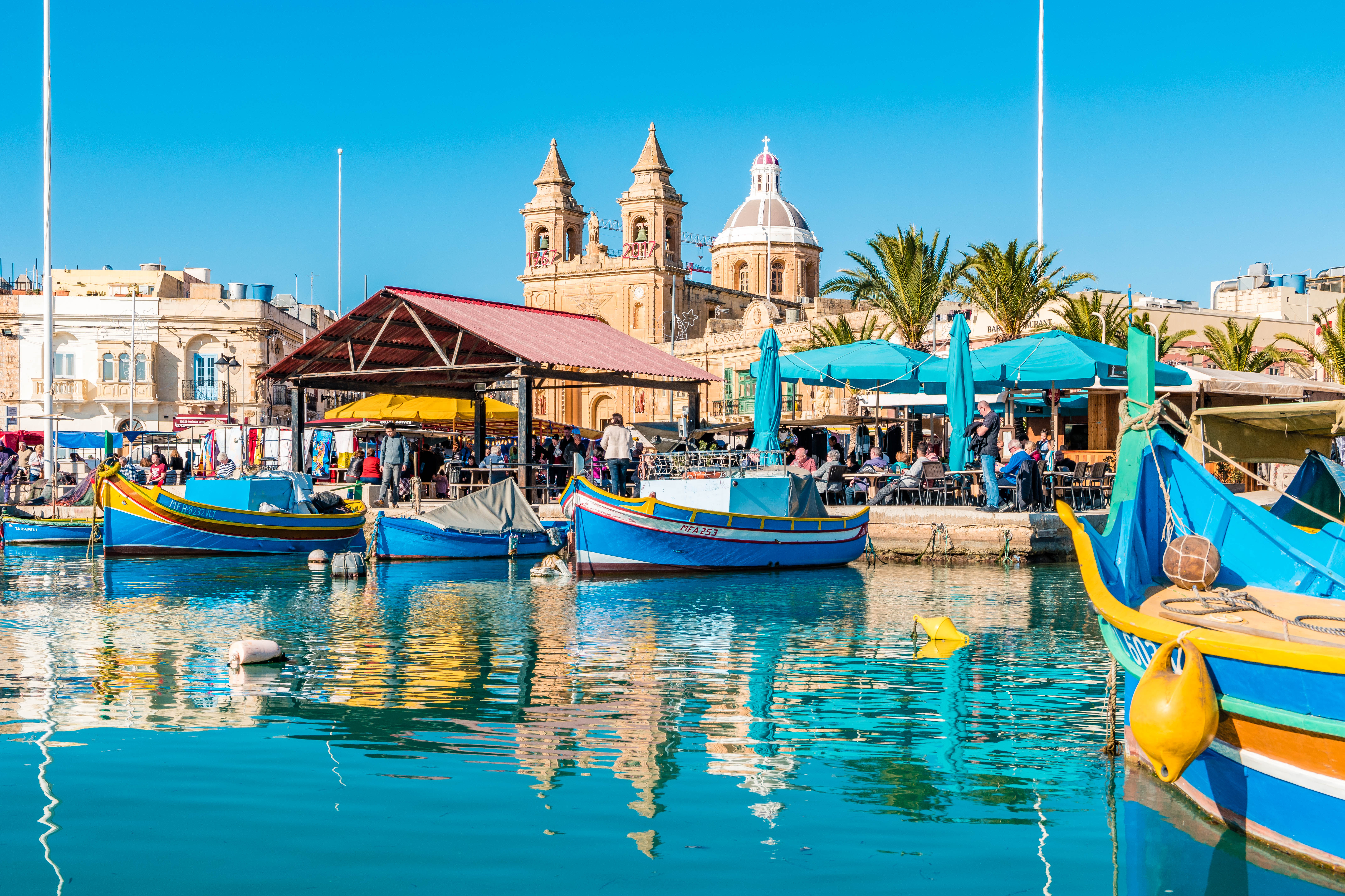 Marsaxlokk Sunday market stalls along the harbour